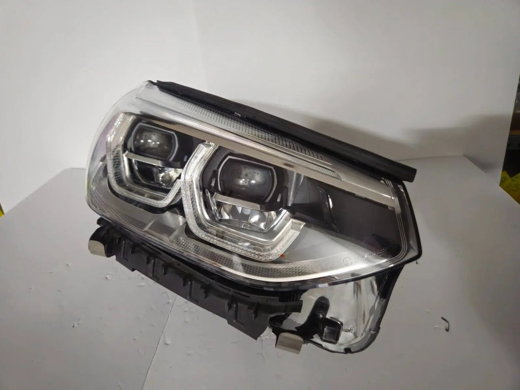 This image displays the right-side ICON Adaptive LED headlight for BMW models iX3 G08, X3 G01, X3 M F97, X4 G02, and X4 M F98, featuring OEM genuine quality with part number 7494052. This used original headlamp offers BMW’s advanced Adaptive LED with ICON design, delivering precise light distribution, dynamic styling, and perfect fitment for these specific models