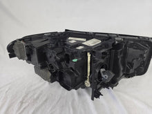 Load image into Gallery viewer, Genuine OEM BMW Laser headlight for 5 Series models G30, G31, and F90 LCI (facelift). This left-side headlamp, part number 5A388D5, is equipped with advanced laser lighting technology for superior visibility and precision on the road. The image displays the original left laser headlight in used condition, clearly showing the lens structure, cooling fins, mounting points, and connector ports — ideal for OEM replacement on compatible BMW 5 Series LCI vehicles.

