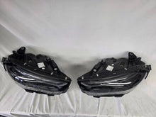 Load image into Gallery viewer, This image showcases the OEM genuine DIGITAL LIGHT headlights for the Mercedes-Benz E-Class W214, available for both right and left sides with part numbers A2149066102 (right) and A2149066202 (left). These advanced headlamps are original Mercedes-Benz components designed for the W214 model, offering cutting-edge DIGITAL LIGHT technology that enhances driving safety and precision lighting. The headlights are used but maintain high-quality OEM standards and are ideal replacements for the corresponding side.