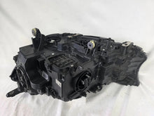 Load image into Gallery viewer, Used genuine BMW Laser headlight for 7 Series models G11 and G12. This right-side OEM headlamp, part number 7465606, features advanced laser lighting technology for superior visibility and performance. The image shows the original BMW right laser headlight in used condition, highlighting the detailed lens design, housing structure, and connector ports — ideal for high-end replacement or repair on compatible 7 Series vehicles.

