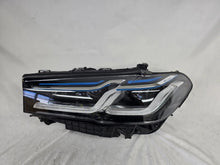 Load image into Gallery viewer, Genuine OEM BMW Laser headlight for 5 Series models G30, G31, and F90 LCI (facelift). This left-side headlamp, part number 5A388D5, is equipped with advanced laser lighting technology for superior visibility and precision on the road. The image displays the original left laser headlight in used condition, clearly showing the lens structure, cooling fins, mounting points, and connector ports — ideal for OEM replacement on compatible BMW 5 Series LCI vehicles.

