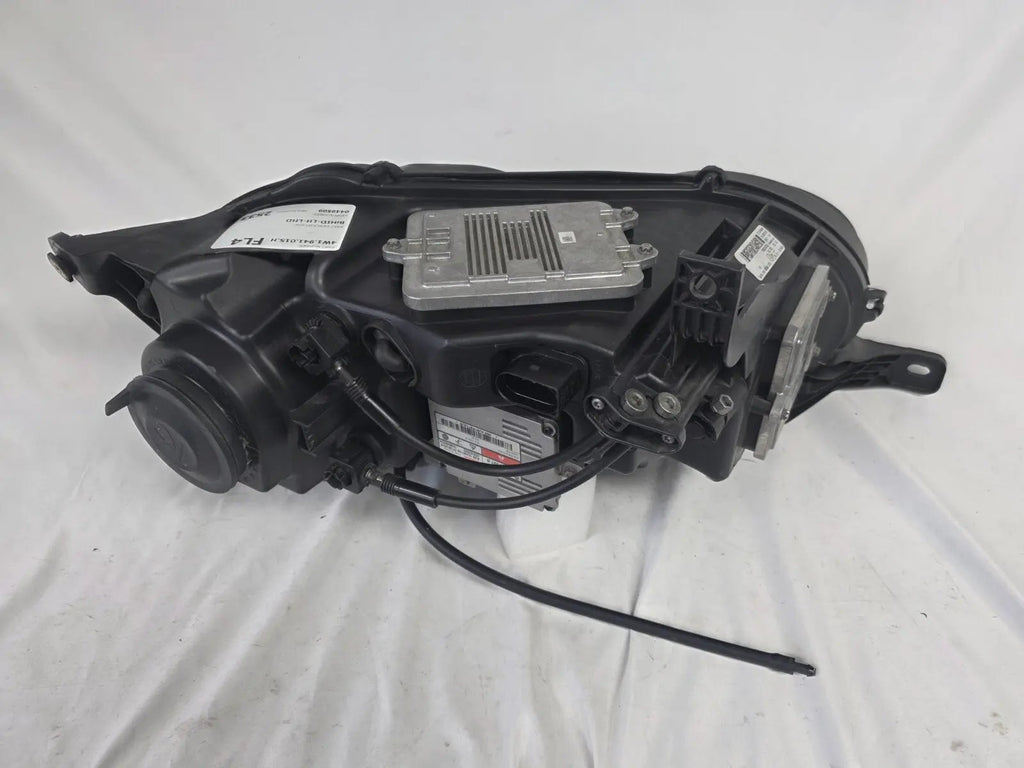 This image shows the left-side headlight for the 2014–2019 Bentley Flying Spur, featuring OEM genuine quality with part number 4W1941015H. This used original headlamp is in excellent condition, offering premium illumination, elegant design, and a precise fit for Bentley’s high-end luxury sedan