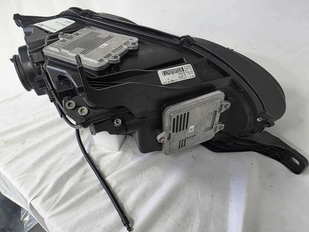 This image shows the left-side headlight for the 2014–2019 Bentley Flying Spur, featuring OEM genuine quality with part number 4W1941015H. This used original headlamp is in excellent condition, offering premium illumination, elegant design, and a precise fit for Bentley’s high-end luxury sedan