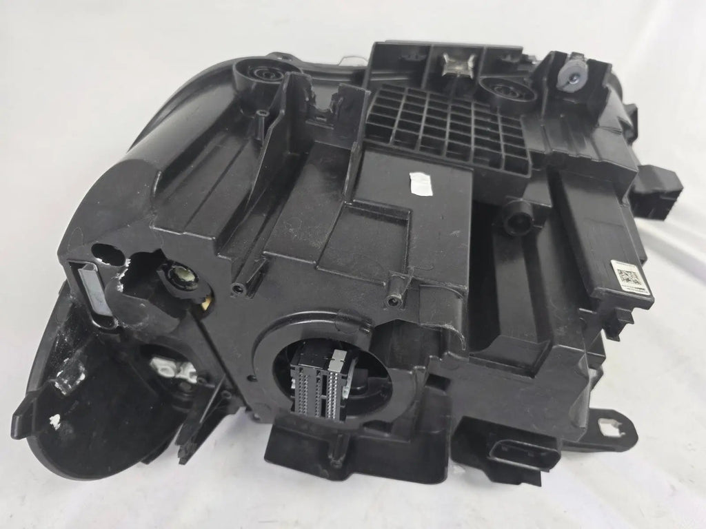 Used genuine BMW Adaptive LED headlight for X1 F48 LCI (facelift) model. This right-side OEM headlamp, part number 5A01178, is equipped with adaptive lighting technology for improved night visibility and cornering performance. The image displays the original right Adaptive LED headlight in used condition, showing the clear lens, mounting brackets, and electrical connectors — an ideal OEM replacement for BMW X1 F48 LCI vehicles.


