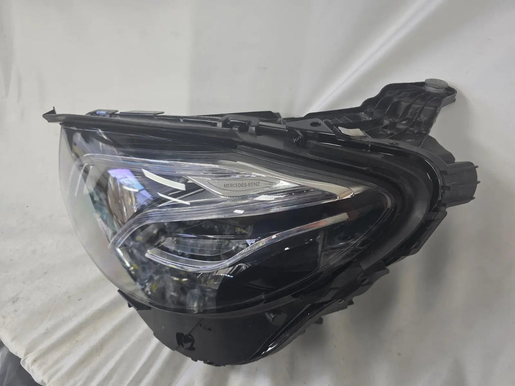 This image displays the left-side Multibeam LED headlight with blue accents for the Mercedes-Benz E-Class W213, featuring OEM genuine quality and part number A2139066504. This original used headlamp is designed for precise fitment on the W213 model, offering advanced Multibeam LED technology with distinctive blue detailing for high-performance adaptive illumination and premium styling