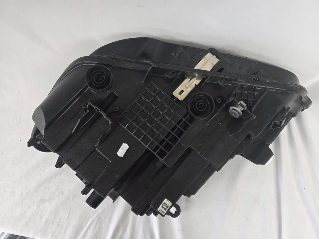 Used genuine BMW Adaptive LED headlight for X1 F48 LCI (facelift) model. This right-side OEM headlamp, part number 5A01178, is equipped with adaptive lighting technology for improved night visibility and cornering performance. The image displays the original right Adaptive LED headlight in used condition, showing the clear lens, mounting brackets, and electrical connectors — an ideal OEM replacement for BMW X1 F48 LCI vehicles.

