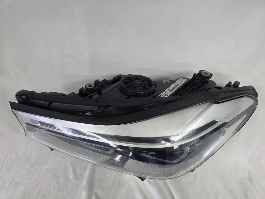 This image shows the left-side Adaptive LED headlight (ICON design) for the BMW 6 Series GT G32 model, featuring OEM genuine quality with part number 7496443. This used original headlamp is designed to deliver advanced Adaptive LED lighting with BMW’s ICON styling, offering precise fitment, enhanced road illumination, and premium performance for the 6 Series Gran Turismo.