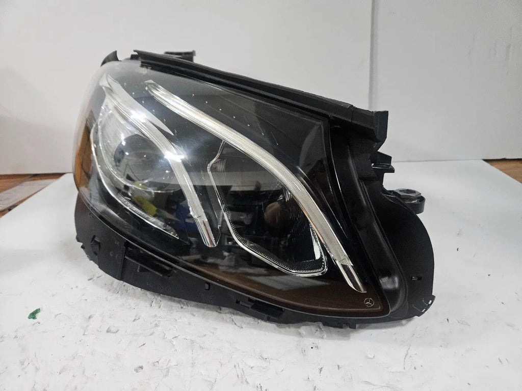 This image features the right-side LED High Performance headlight for the Mercedes-Benz E-Class W213, showcasing OEM genuine quality with part number A2139064004. Specifically designed for the W213 model, this used headlight offers high-performance LED illumination and is an original Mercedes-Benz component, ensuring precise fit and reliable functionality