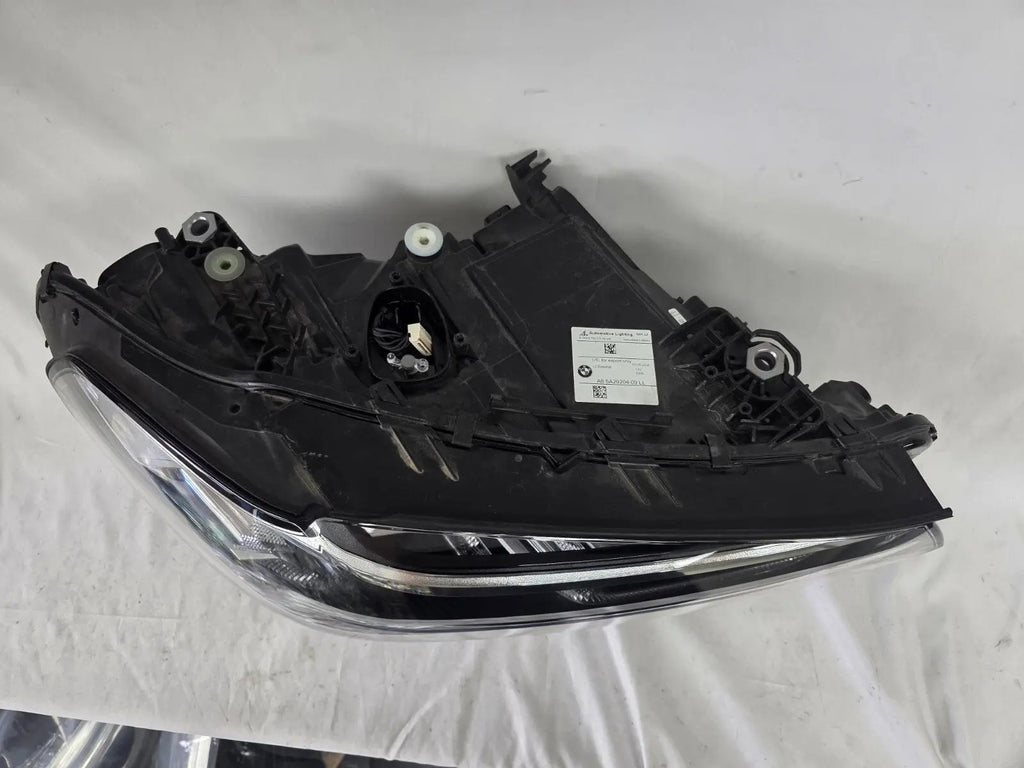 Genuine OEM Adaptive LED headlight for BMW iX3 and compatible models including G08, G01, F97, G02, and F98 with LCI (facelift) updates. This right-side headlamp, part number 5A29204, features adaptive lighting technology for enhanced road illumination and driving safety. The image showcases the original right LED headlight in used condition, clearly showing the lens, housing, and connector points — perfect for replacement on BMW iX3 and related LCI models.