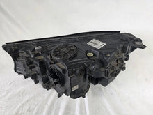 Load image into Gallery viewer, Used genuine BMW Laser headlight for 7 Series models G11 and G12. This right-side OEM headlamp, part number 7465606, features advanced laser lighting technology for superior visibility and performance. The image shows the original BMW right laser headlight in used condition, highlighting the detailed lens design, housing structure, and connector ports — ideal for high-end replacement or repair on compatible 7 Series vehicles.

