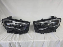 Load image into Gallery viewer, This image showcases the OEM genuine DIGITAL LIGHT headlights for the Mercedes-Benz E-Class W214, available for both right and left sides with part numbers A2149066102 (right) and A2149066202 (left). These advanced headlamps are original Mercedes-Benz components designed for the W214 model, offering cutting-edge DIGITAL LIGHT technology that enhances driving safety and precision lighting. The headlights are used but maintain high-quality OEM standards and are ideal replacements for the corresponding side.