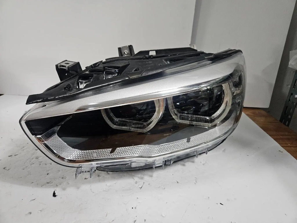 This image shows the left-side LED headlight for the BMW 1 Series F20 and F21 LCI (facelift) models, featuring OEM genuine quality with part number 7435777. This used original headlamp is specifically designed for the facelifted 1 Series, offering bright and efficient LED lighting, precise fitment, and the durability expected from authentic BMW components.