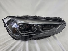 Load image into Gallery viewer, Used genuine BMW Adaptive LED headlight for X1 F48 LCI (facelift) model. This right-side OEM headlamp, part number 5A01178, is equipped with adaptive lighting technology for improved night visibility and cornering performance. The image displays the original right Adaptive LED headlight in used condition, showing the clear lens, mounting brackets, and electrical connectors — an ideal OEM replacement for BMW X1 F48 LCI vehicles.
