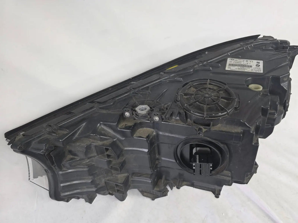 Used genuine BMW Laser headlight for 7 Series models G11 and G12. This right-side OEM headlamp, part number 7465606, features advanced laser lighting technology for superior visibility and performance. The image shows the original BMW right laser headlight in used condition, highlighting the detailed lens design, housing structure, and connector ports — ideal for high-end replacement or repair on compatible 7 Series vehicles.