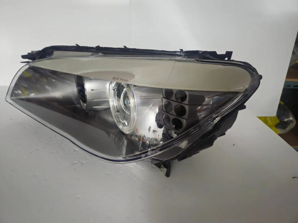 This image features the left-side Xenon headlight for the BMW 7 Series F01/F02 models, showcasing used OEM genuine quality with part number 7225229. Designed specifically for the F01 and F02 chassis, this original headlamp offers high-intensity Xenon lighting and precise fitment for the left side, ensuring reliable performance and compatibility.