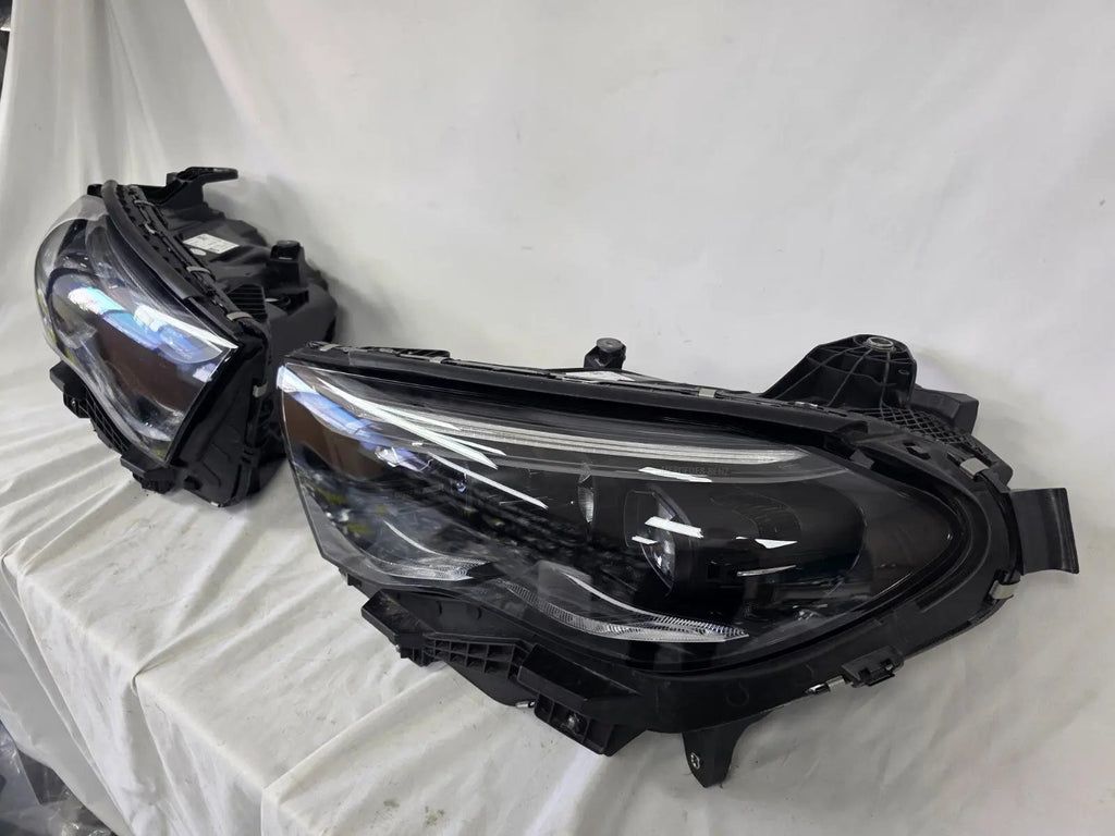 This image showcases the OEM genuine DIGITAL LIGHT headlights for the Mercedes-Benz E-Class W214, available for both right and left sides with part numbers A2149066102 (right) and A2149066202 (left). These advanced headlamps are original Mercedes-Benz components designed for the W214 model, offering cutting-edge DIGITAL LIGHT technology that enhances driving safety and precision lighting. The headlights are used but maintain high-quality OEM standards and are ideal replacements for the corresponding side.