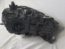 Load image into Gallery viewer, Used genuine BMW Laser headlight for 7 Series models G11 and G12. This right-side OEM headlamp, part number 7465606, features advanced laser lighting technology for superior visibility and performance. The image shows the original BMW right laser headlight in used condition, highlighting the detailed lens design, housing structure, and connector ports — ideal for high-end replacement or repair on compatible 7 Series vehicles.

