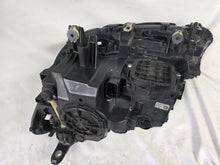Load image into Gallery viewer, Used genuine BMW Laser headlight for 7 Series models G11 and G12. This right-side OEM headlamp, part number 7465606, features advanced laser lighting technology for superior visibility and performance. The image shows the original BMW right laser headlight in used condition, highlighting the detailed lens design, housing structure, and connector ports — ideal for high-end replacement or repair on compatible 7 Series vehicles.

